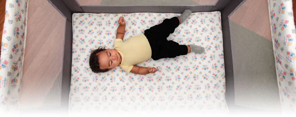 Baby sleeping on his back in a pack and play