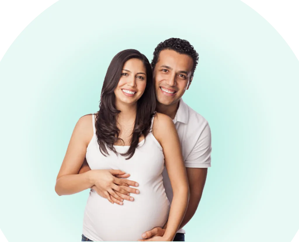 pregnant mother and father smiling with hugging