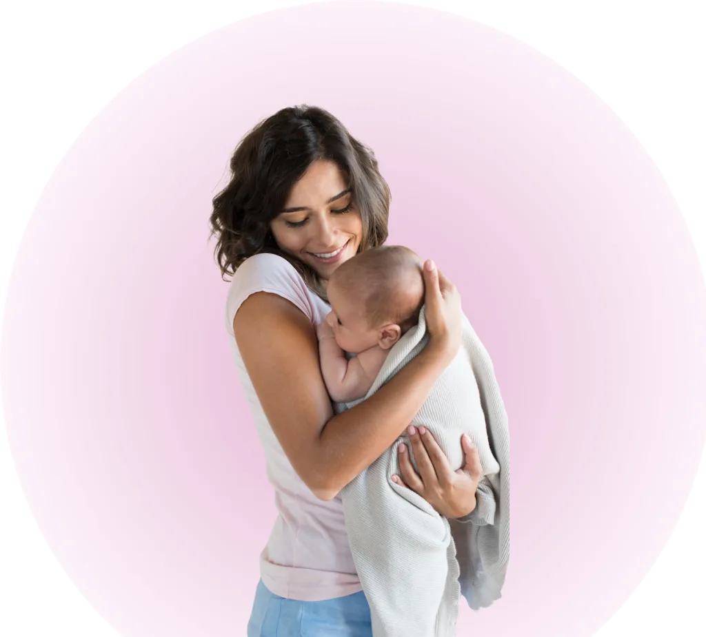 mother holding a newborn baby wrapped in a blanket