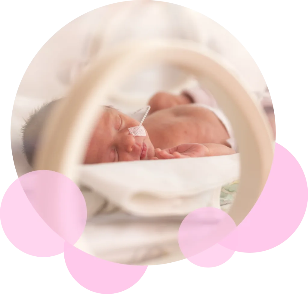 baby asleep in an incubator