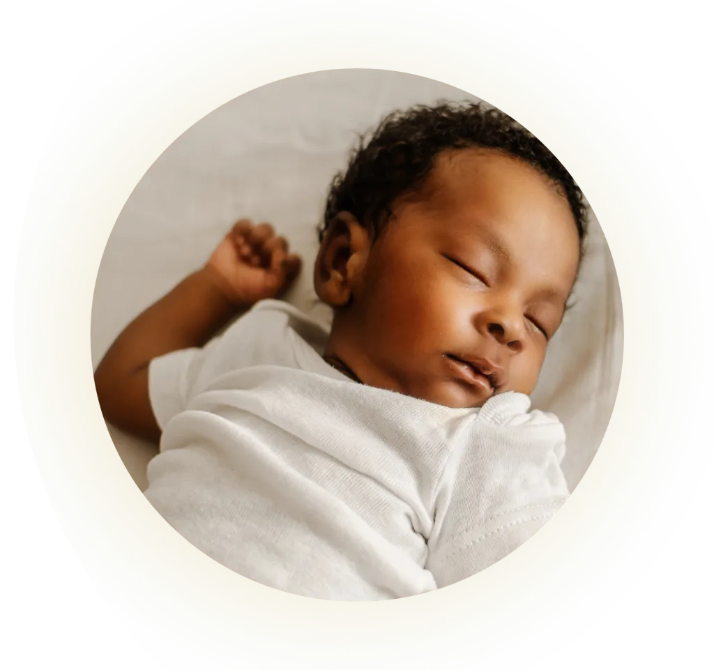 baby asleep on her back in a crib
